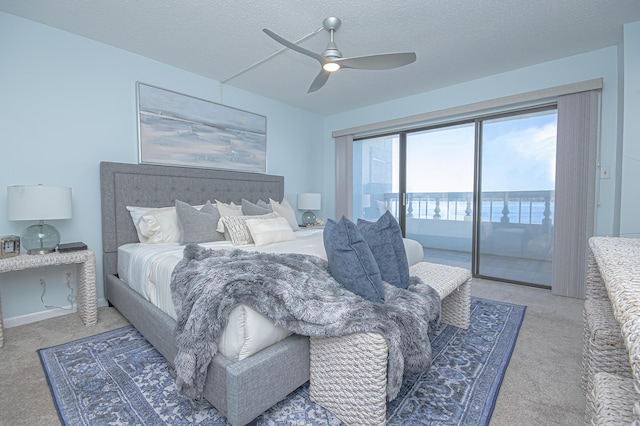 bedroom with light colored carpet, a textured ceiling, ceiling fan, and access to outside