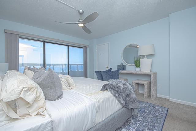 carpeted bedroom with baseboards, a textured ceiling, and a ceiling fan