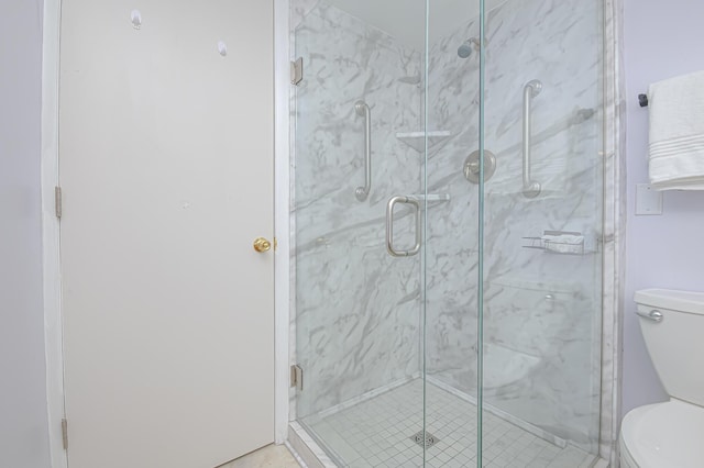 full bath with a marble finish shower and toilet