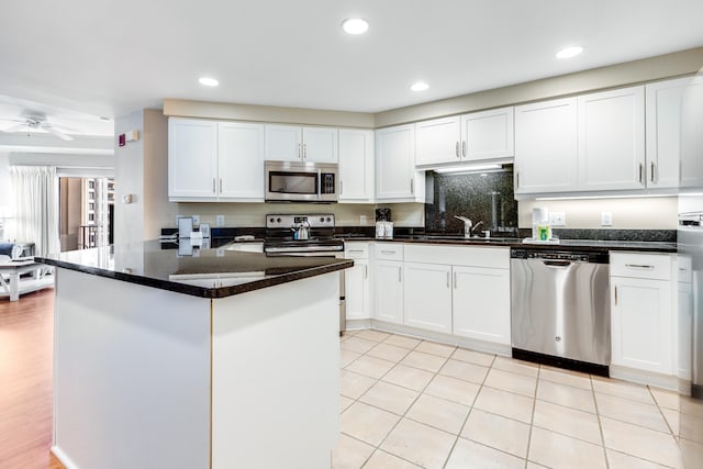4776 Westwinds Dr Unit 4776, Miramar Beach, FL 32550 - kitchen featuring appliances with stainless steel finishes, white cabinetry, recessed lighting, ceiling fan, and backsplash