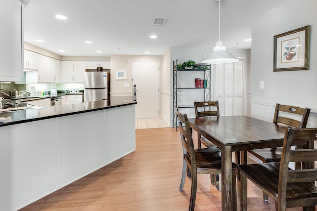 dining room featuring light hardwood / wood-style floors and sink