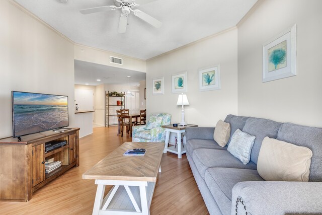 4776 Westwinds Dr Unit 4776, Miramar Beach, FL 32550 - living room featuring crown molding, light wood-style flooring, and a ceiling fan