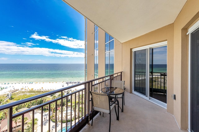 balcony featuring a water view and a view of the beach