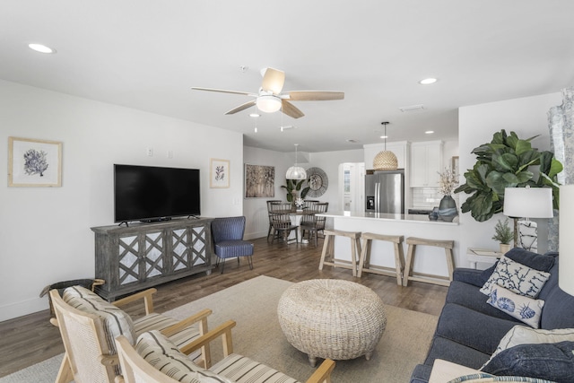 living room with ceiling fan and dark hardwood / wood-style floors