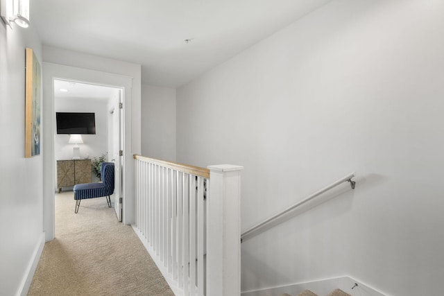 hallway featuring light carpet