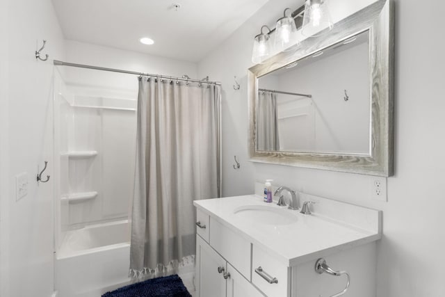 bathroom featuring vanity and shower / bathtub combination with curtain