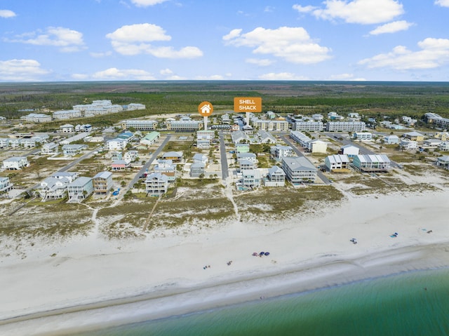 birds eye view of property featuring a view of the beach and a water view