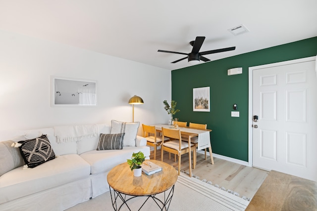 living room featuring ceiling fan and hardwood / wood-style flooring