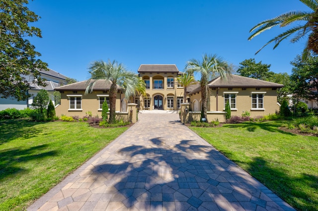 mediterranean / spanish-style house with a front yard