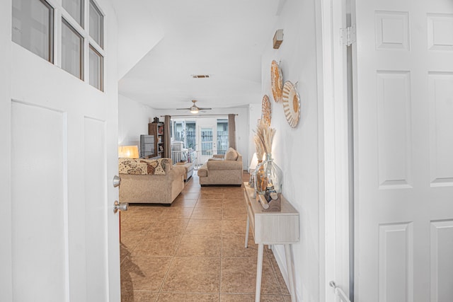 living room featuring ceiling fan and light tile patterned floors