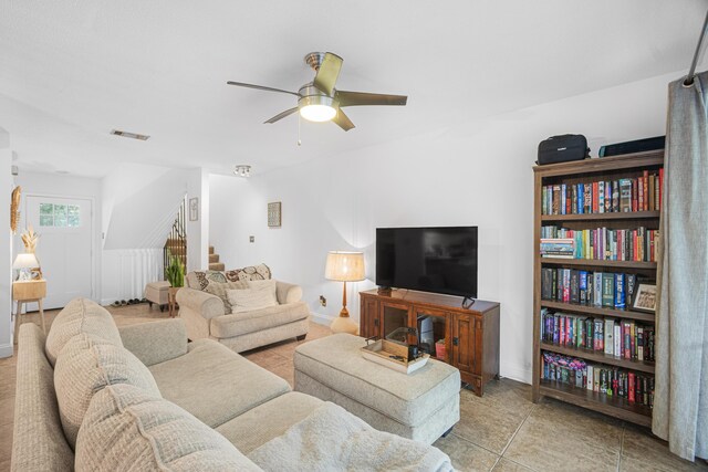 living room featuring light tile patterned floors and ceiling fan