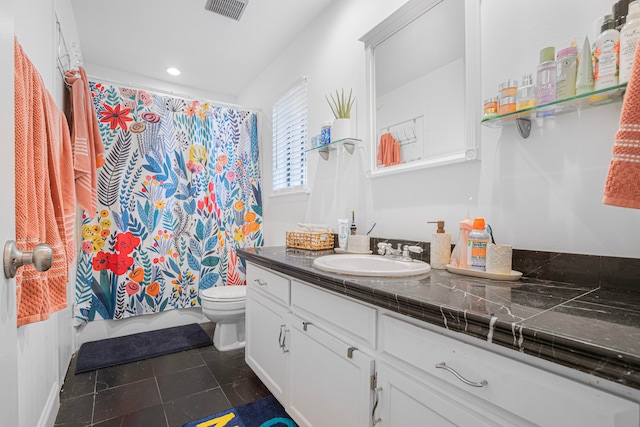 bathroom with tile patterned flooring, vanity, and toilet