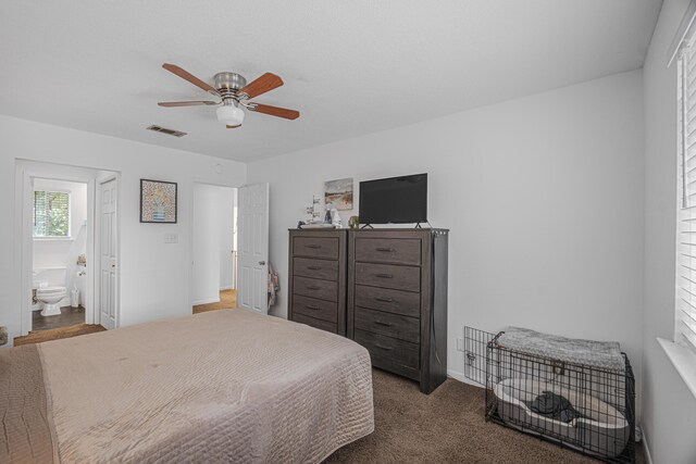 carpeted bedroom featuring ensuite bath and ceiling fan