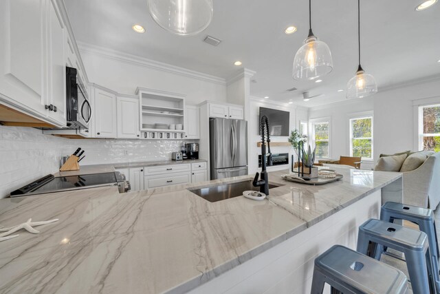 kitchen featuring appliances with stainless steel finishes, a healthy amount of sunlight, and white cabinets