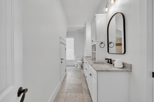 bathroom featuring vanity, toilet, and tile patterned floors