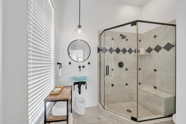 bathroom with an enclosed shower and tile patterned floors