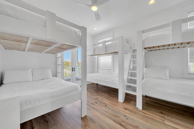 bedroom with wood-type flooring, ceiling fan, and access to outside