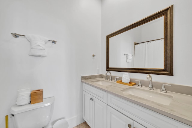 bathroom featuring vanity and toilet