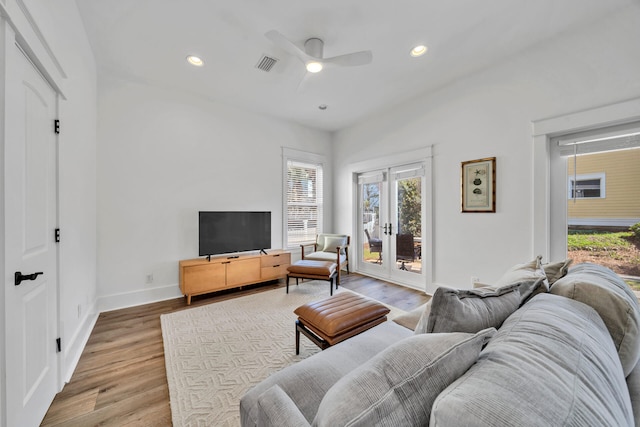 living room with light wood-type flooring, french doors, plenty of natural light, and ceiling fan