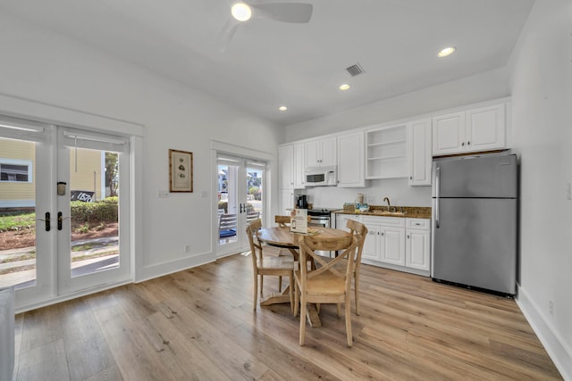 kitchen with plenty of natural light, sink, appliances with stainless steel finishes, and french doors