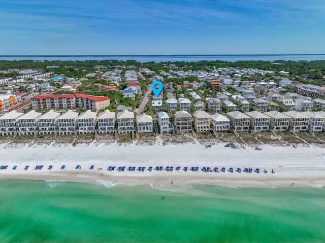 birds eye view of property featuring a view of the beach and a water view