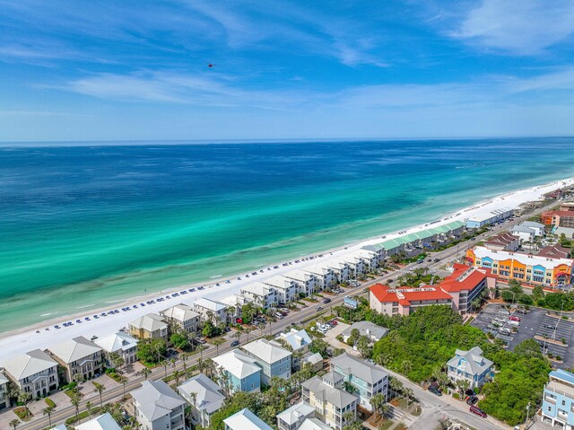 bird's eye view featuring a water view and a beach view