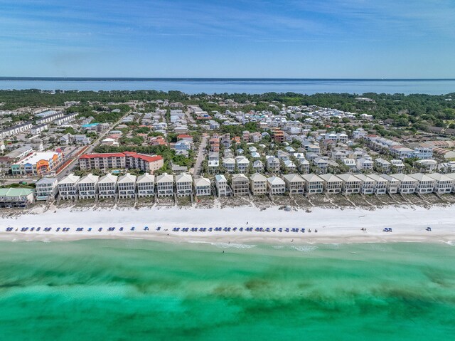 drone / aerial view with a beach view and a water view