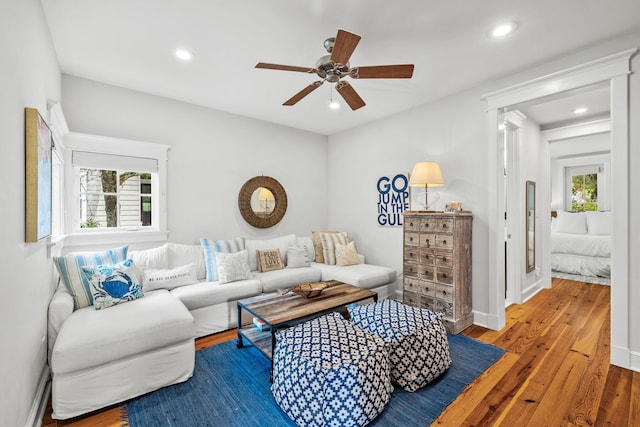 living room featuring hardwood / wood-style flooring and ceiling fan