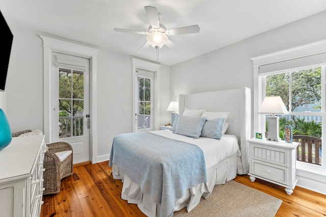 bedroom featuring light hardwood / wood-style flooring, ceiling fan, and access to outside