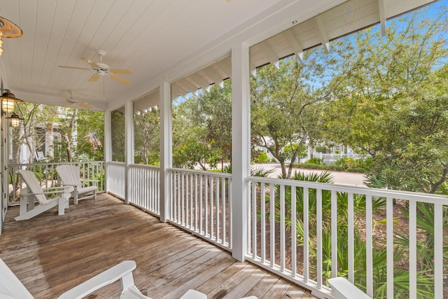 wooden terrace featuring ceiling fan and covered porch