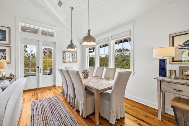 dining room with lofted ceiling, light wood-type flooring, and wooden ceiling