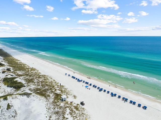 birds eye view of property featuring a view of the beach and a water view