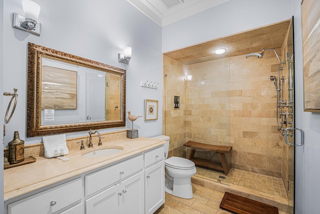 bathroom with ornamental molding, vanity, toilet, and walk in shower