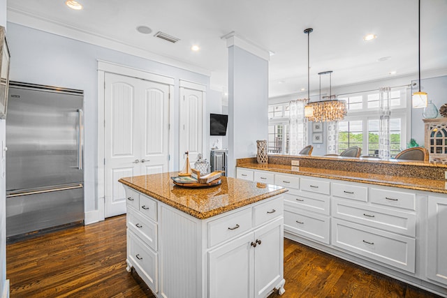 kitchen with a center island, white cabinets, dark hardwood / wood-style flooring, and stainless steel built in fridge