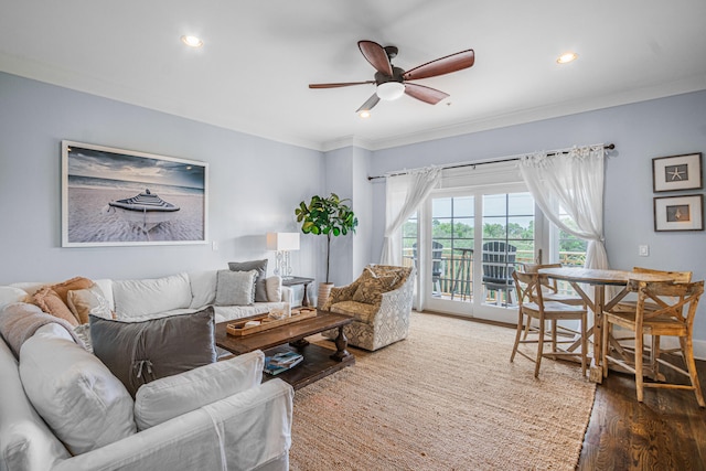 living room with ornamental molding, ceiling fan, and dark hardwood / wood-style floors