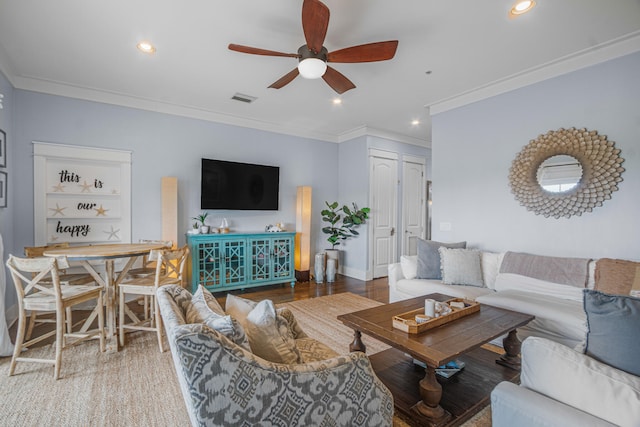 living room with ornamental molding, hardwood / wood-style floors, and ceiling fan