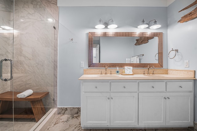 bathroom featuring a shower with shower door and vanity