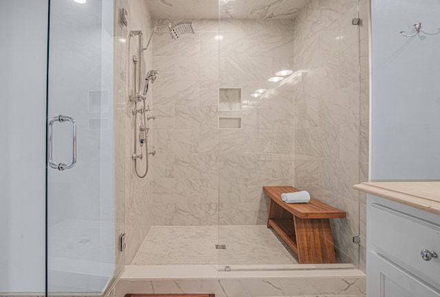 bathroom with vanity, tile walls, and a shower with shower door