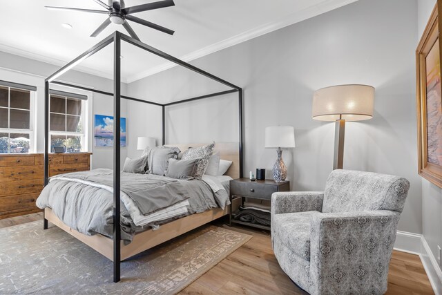 bedroom with ceiling fan, crown molding, and wood-type flooring