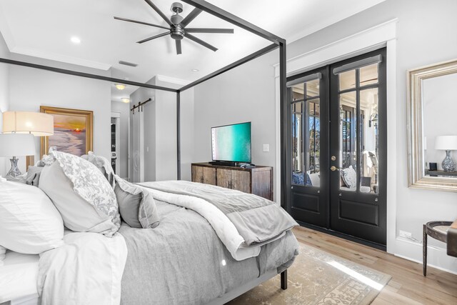 bedroom featuring light wood-type flooring, ceiling fan, access to exterior, and french doors