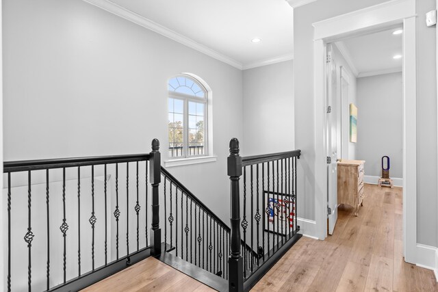 staircase featuring ornamental molding and hardwood / wood-style flooring