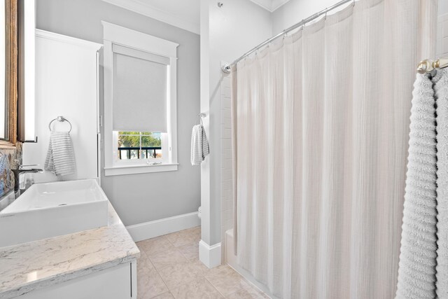 full bathroom featuring shower / bath combo with shower curtain, vanity, crown molding, tile patterned flooring, and toilet