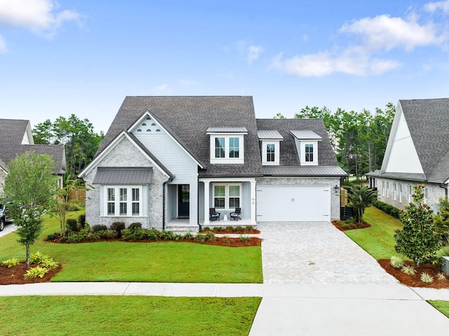 view of front of home featuring a garage and a front lawn