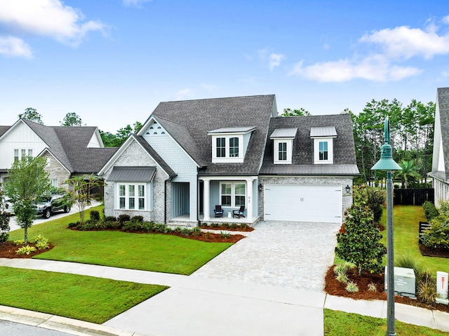 view of front of house featuring a front yard and a garage