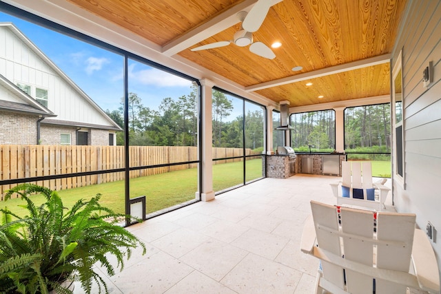 sunroom / solarium with wooden ceiling and ceiling fan