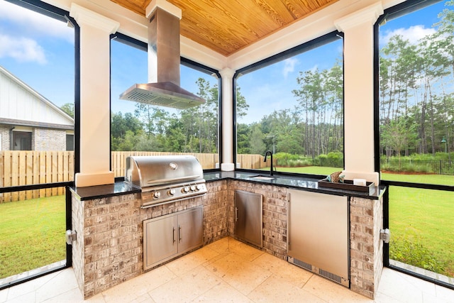 view of patio with exterior kitchen, area for grilling, and sink