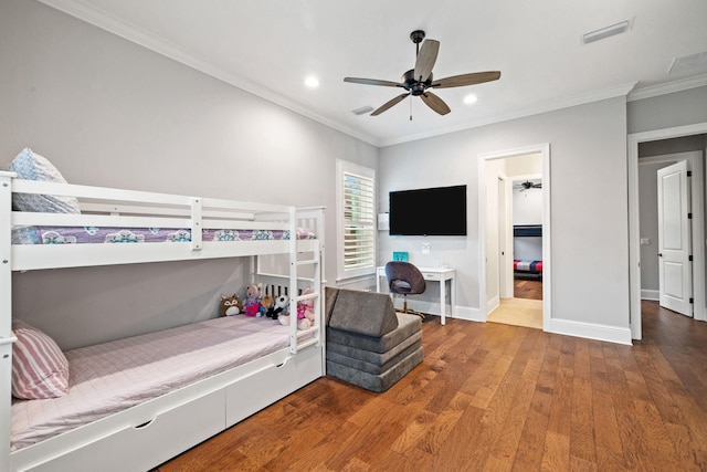 bedroom featuring ornamental molding, wood-type flooring, and ceiling fan