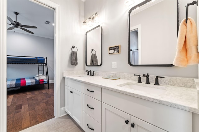 bathroom featuring ornamental molding, ceiling fan, hardwood / wood-style flooring, and vanity