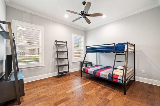 bedroom featuring multiple windows, ceiling fan, and hardwood / wood-style flooring