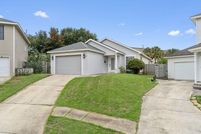 view of front of property with a front yard and a garage